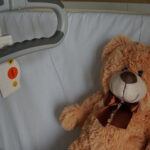 Sick teddy bear in a hospital bed